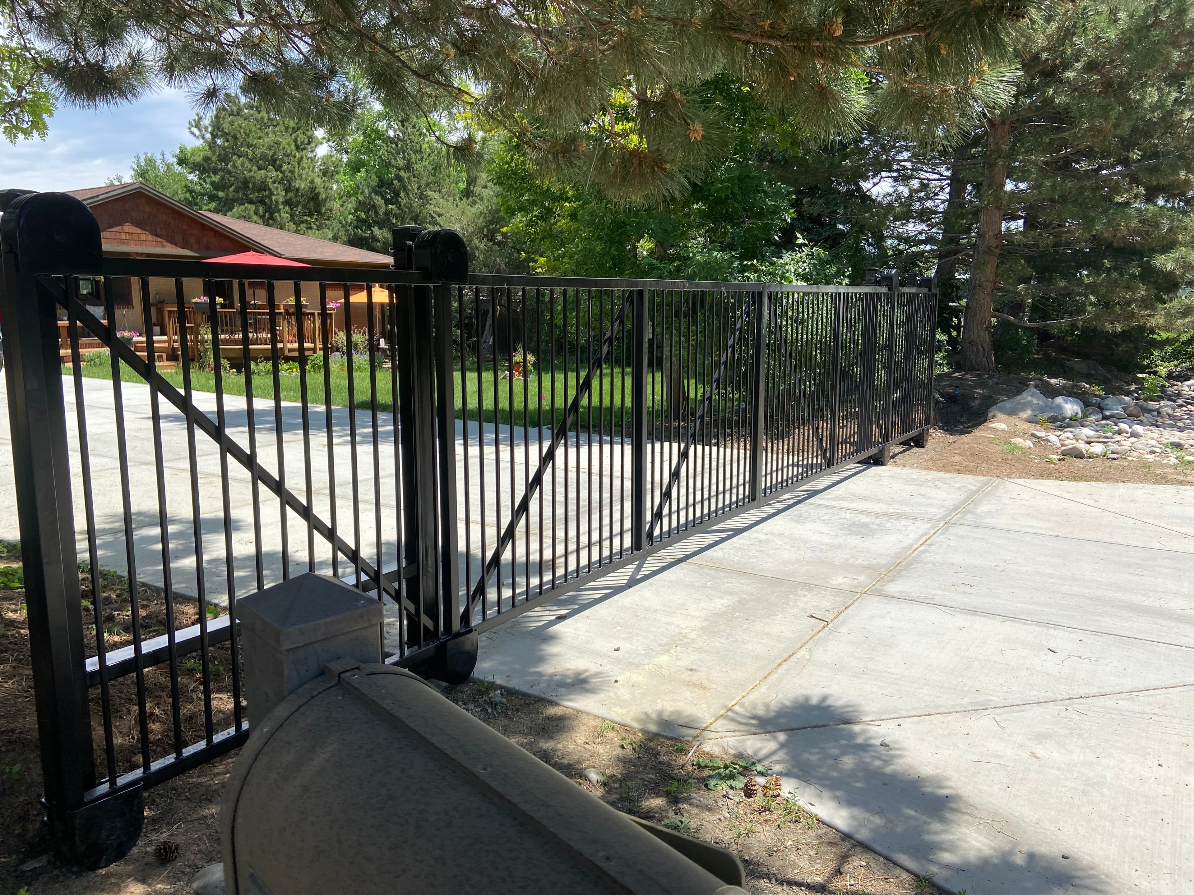 Bi-parting ornamental iron cantilever slide gates powder coated in Lakewood, CO