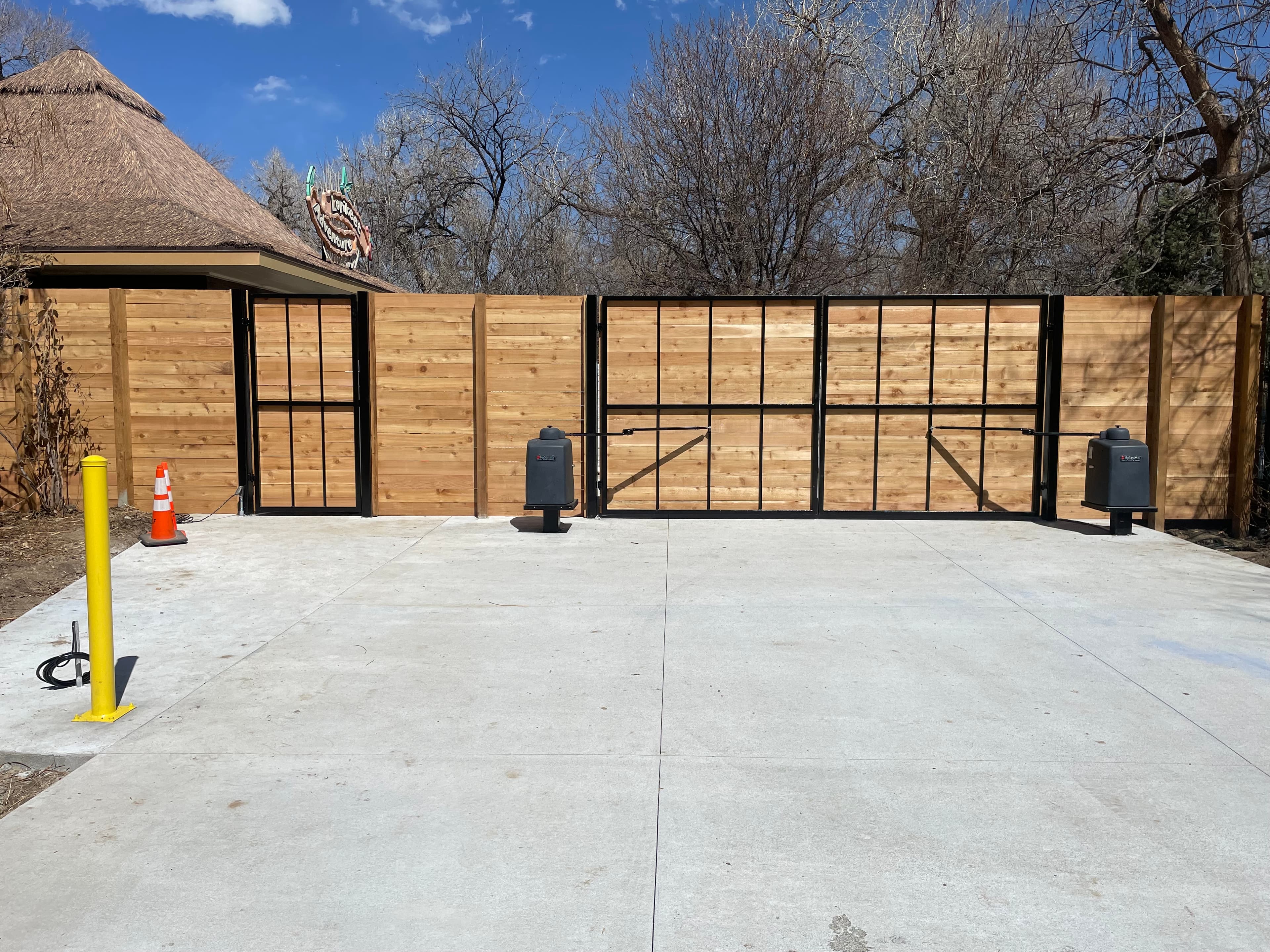 Bi-parting ornamental iron swing gates with cedar infill and HySecurity SwingSmart DC20 plus Locinox closer in Denver, CO