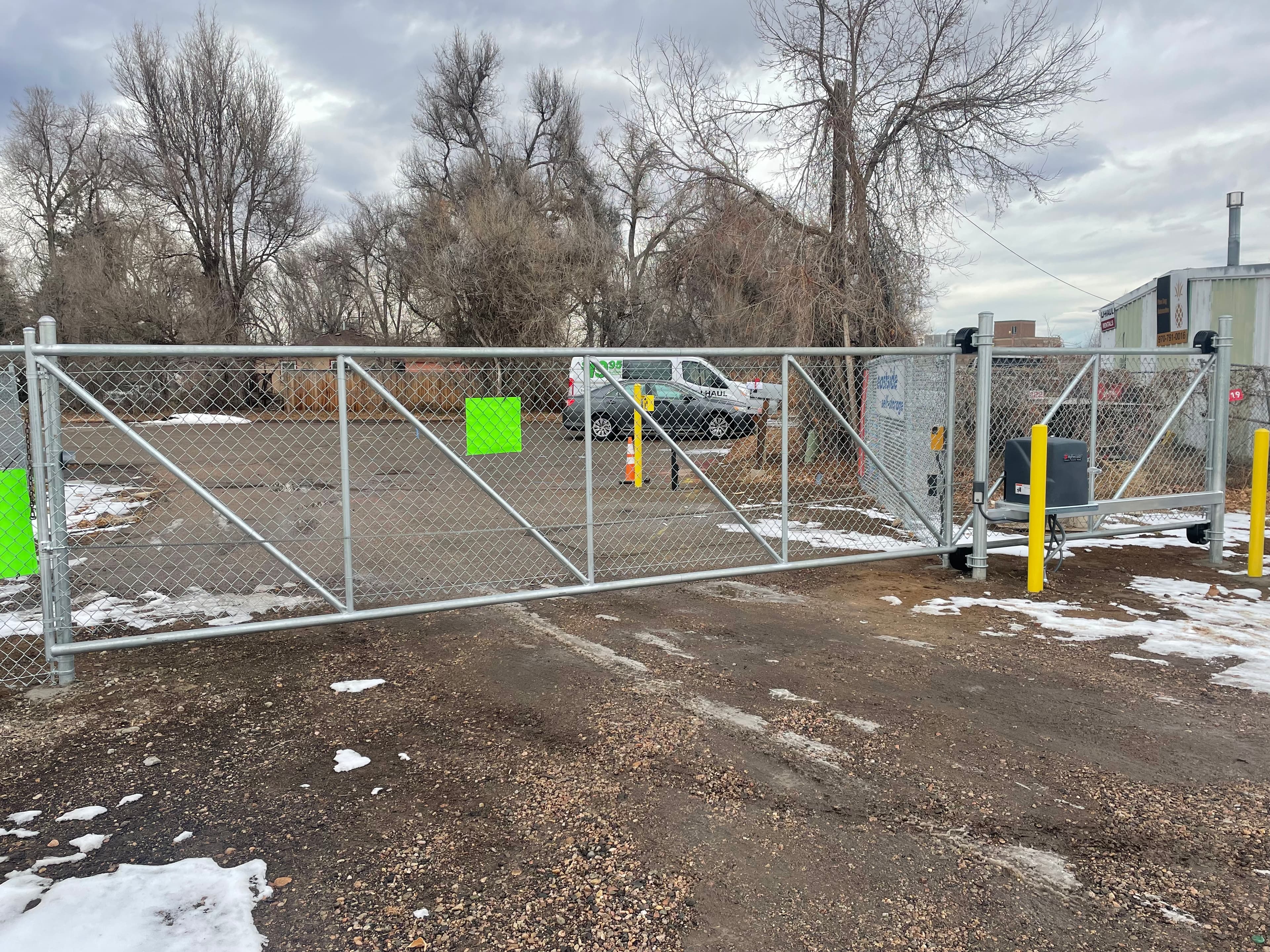 Chain-link cantilever slide with HySecurity SlideSmart DC15, OpenTech keypad and protective bollards in Loveland, CO